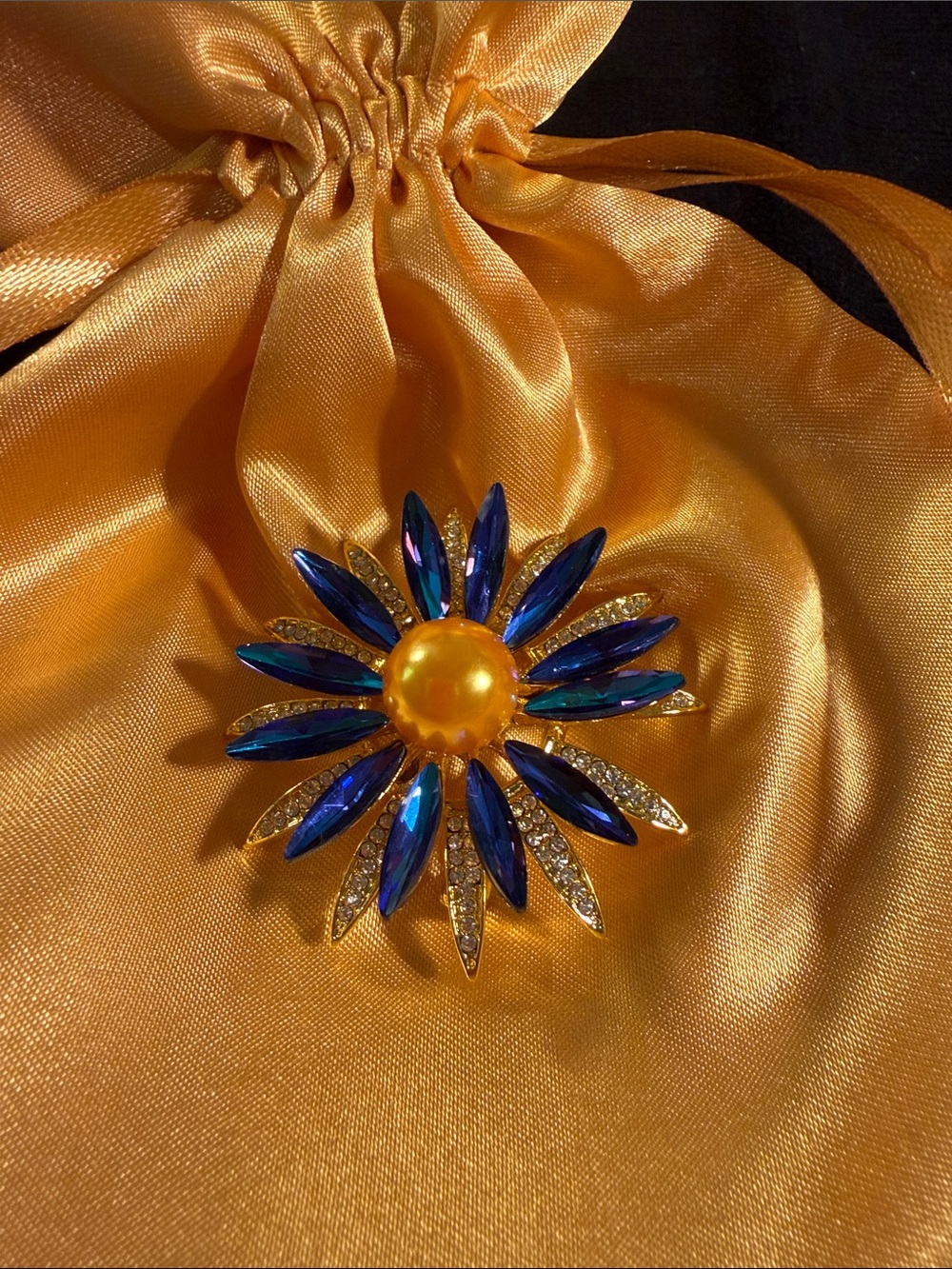 Gold-Tone Brooch with Blue Marquise rhinestones and Amber bead Center. NWOT